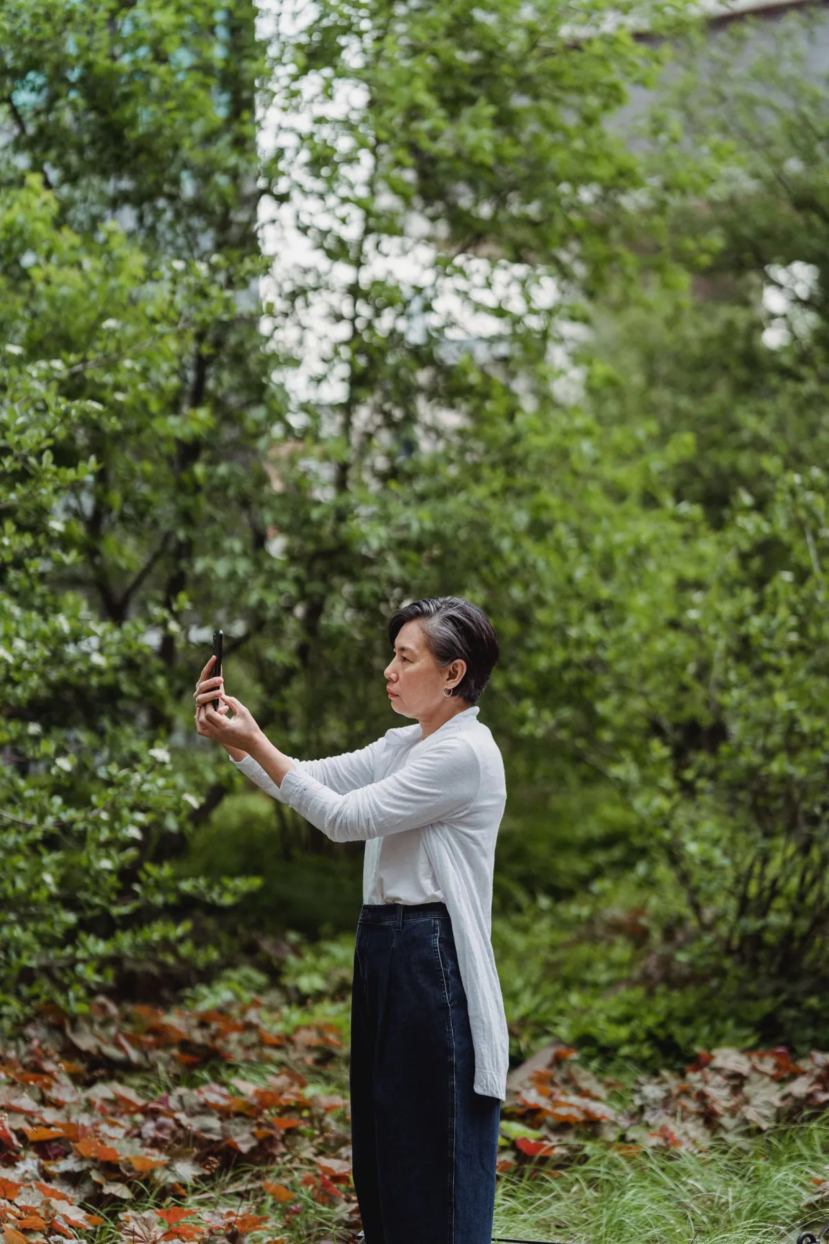 A person taking a photo with a smartphone outdoors
